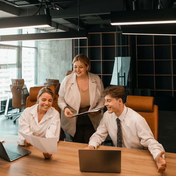 young-dark-haired-businesswoman-wearing-striped-shirt-is-sitting-her-office-looking-into-laptop-her-notebook-pencil-are-lying-desk-bright-modern-office 1-min